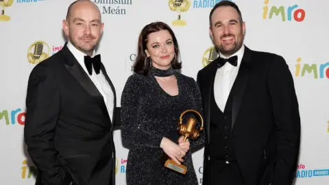 Andres Poveda Evening Extra presenters Declan Harvey and Richard Morgan, with producer Gráinne Deeney, celebrate the team's win in the News Programme category