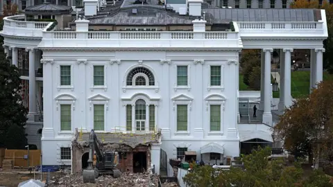 An excavator sits on the rubble after the East Wing of the White House was demolished on October 28, 2025