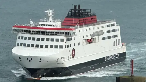 The Manxman ferry, which is painted in the Steam Packet's livery of red, black and white, sailing into Douglas Harbour.