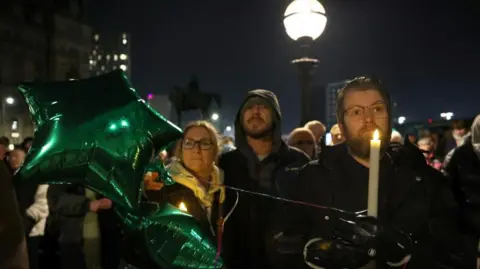 Reuters Image shows people attending a vigil for James Lee Williams, popularly known as The Vivienne, in Liverpool, Britain, on 12 January, 2025



