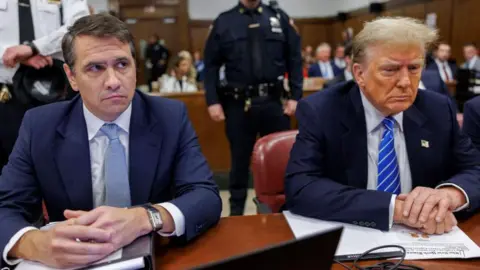 Todd Blanche sits next to President Trump in a courtroom during the 2024 hush money trial