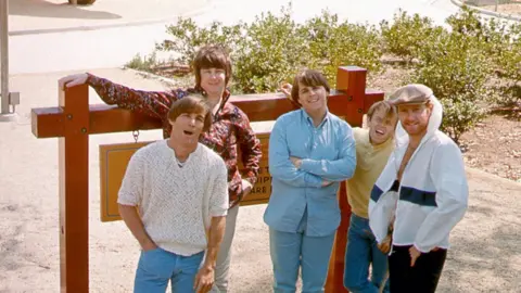 Getty Images The Beach Boys in 1965 (from left to right): Dennis Wilson, Brian Wilson, Carl Wilson, Al Jardin and Mike Love