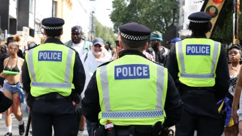 Police patrol the Notting Hill Carnival in London on 26 August 2024.