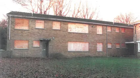 West Yorkshire Police Skircoat Lodge care home in Halifax, a boarded-up, two-storey red-brick building.