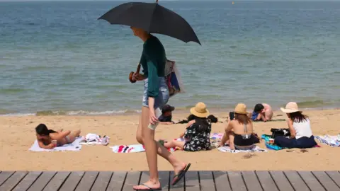 Reuters People flock to St Kilda beach as a heat wave sweeps across Victoria, Australia, 18 December, 2019.