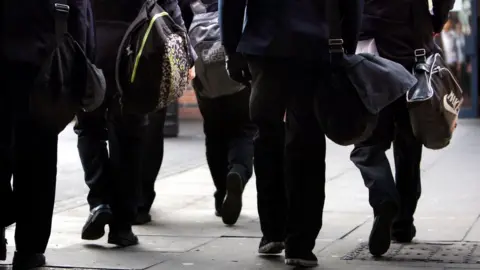 PA Media Male pupils in uniform walking together