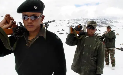 AFP Indian Army soldiers of the Gorkha Regiment carry weapons as they walk through snow, along the India-China border at the height of 16,000ft near Tawang,some 580km from Itanagar, state capital of Arunachal Pradesh, 31 October 2003.