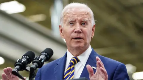 Reuters President Biden speaks from a podium during a visit to an engineering facility in Milwaukee