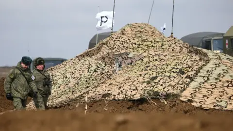 Getty Images A camouflage net covers military hardware during an exercise held by units of the Novorossiysk guards mountain air assault division of the Russian Airborne Troops at Opuk range