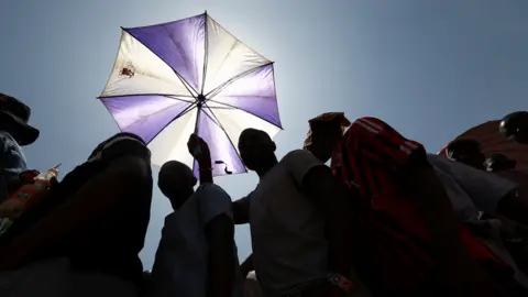 Reuters Voters under an umbrella in Yola, Nigeria - Saturday 25 February 2023