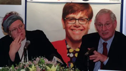 Pacemaker Mo Mowlam and Jim Aiken at a press conference about Elton John's concert at Stormont