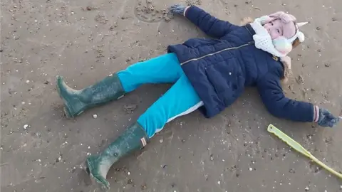 Naomi  Bella playing in the sand