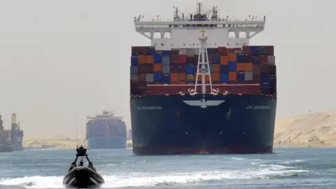 A cargo ship is pictured travelling through the Suez canal