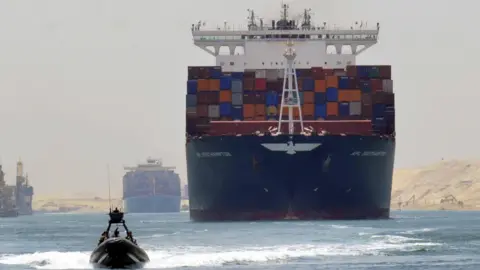 Reuters A cargo ship is pictured travelling through the Suez canal