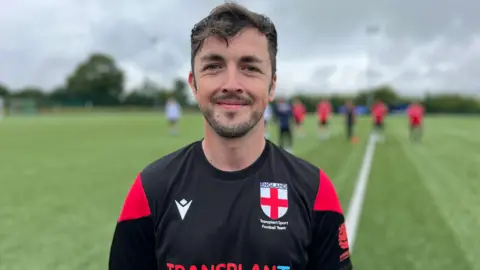 Nicola Haseler/BBC Jack Booth, who has brown hair and is smiling at the camera