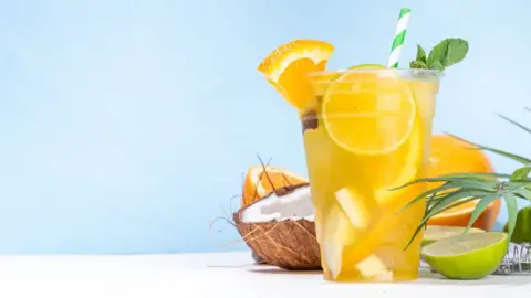 Getty Images A cortisol cocktail in a large plastic glass - a blend of orange, coconut water and sea salt 