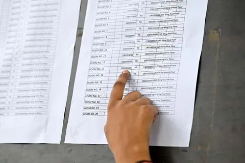 Hindustan Times via Getty Images Candidates check room and roll number at the exam centre to appear for the National Eligibility-cum-Entrance Test (NEET-UG) 2026 (Re-Exam) in Gurgaon