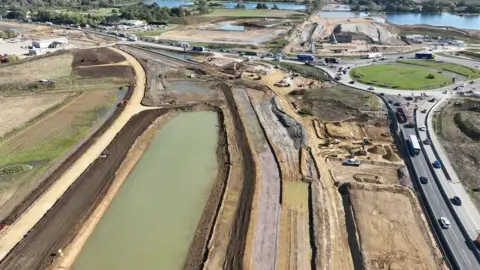 A view of the road from a drone shows the black cat roundabout and construction work around it