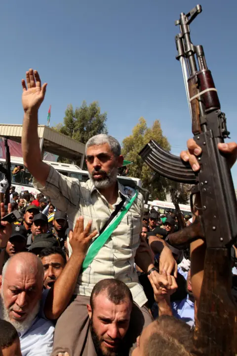 Reuters Hamas leader Yahya Sinwar gestures as he arrives with Palestinian prisoners in southern Gaza on 18 October, 2011.