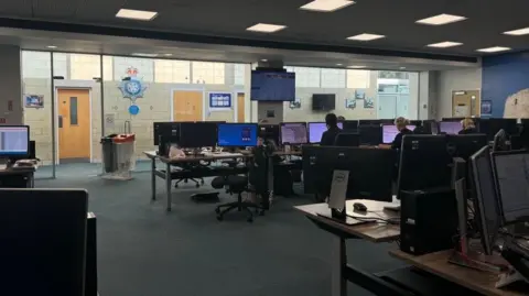 BBC/ Emily Johnson Rows of computers and call handlers in the York control room