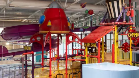 North Lanarkshire Council A bright, multi coloured array of slides above a swimming pool