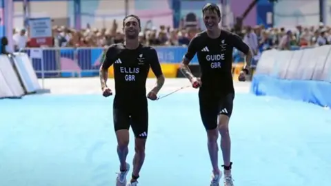 Dave Ellis and guide Luke Pollard crossing the finish line in Paris