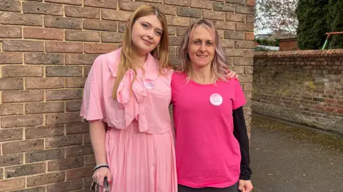 Tony Fisher/BBC Rowan and her mum dressed in pink and smiling