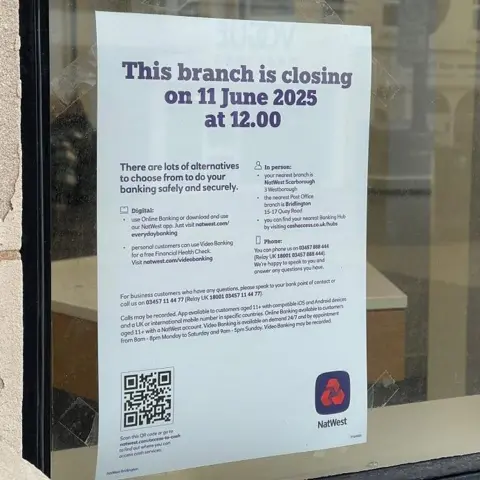 A sign in a window saying one of the NatWest branches will close on 11 June at 12:00 GMT