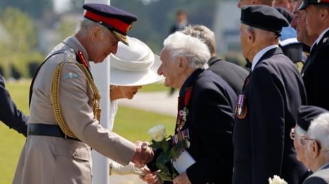 King Charles shakes hands with a D-Day veteran