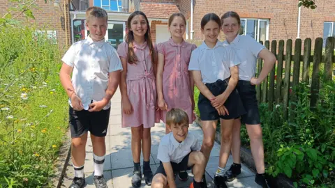 Stoborough Primary School Six students stood outside the school building