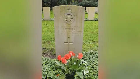 Supplied Grave of sergeant Jack Webber. Fresh roses have been placed on his grave 