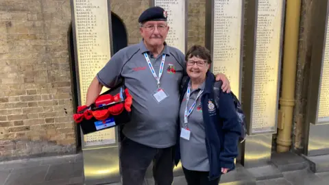 Denis with his poppy collections in one are and his other around his wife Barbara
