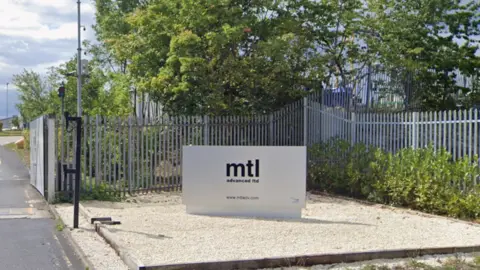 An entrance sign to MTL Advanced Ltd. The sign is silver with MTL Advanced Ltd written in bold black text.