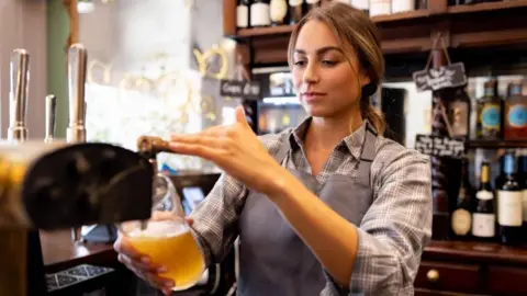 Woman pouring a pint