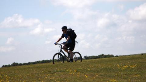 A man cycling down a hill