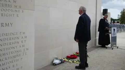 PA Media John Green stands in front of the British Normandy Memorial