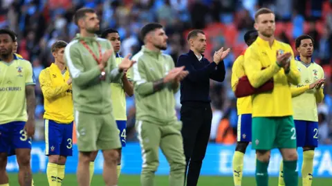 Reuters/Paul Childs Southampton manager Tonda Eckert applauds fans after the FA Cup semi-final against Manchester at Wembley Stadium. Some of the team players are around him.
