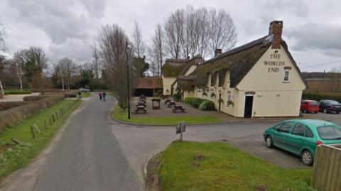 A Google Street View image of The Worlds End Inn, a country pub with a thatched roof