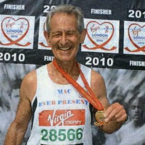 Mac Speake Mac wearing his white Ever Present vest with a medal 