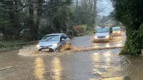 Andrew Snart Cars drive through flood water on the Isle of Wight