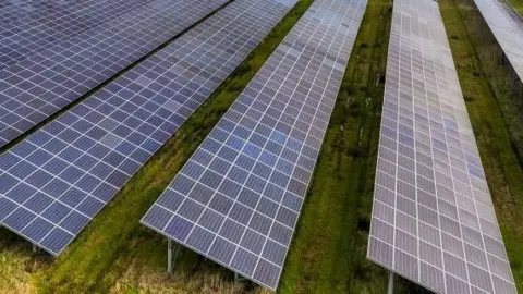 A close up of solar panels in a field
