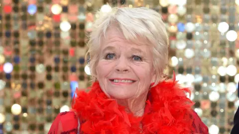 Getty Images Judith Chalmers in a red dress