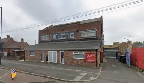 Lou's Diner in Fossway, Newcastle. It is a two-storey, red-brick building with a red sign.