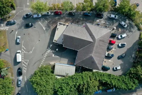 Christopher Furlong / Getty Images An aerial view of cars queuing for fuel