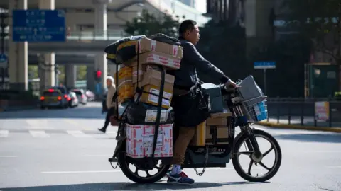 AFP Image shows a delivery man in Shanghai on 11 November 2017