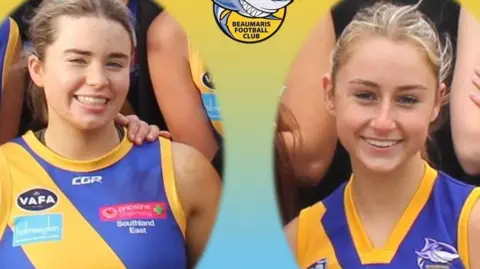 Beaumaris Football Club A picture of Holly Bowles and her friend Bianca Jone, wearing yellow and purple tops of their sports team in an official photo