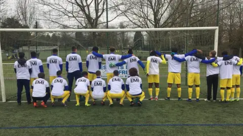 FC Nantes The under-19s at FC Nantes pose for pictures - wearing t-shirts with the words 'We Love You Emi'