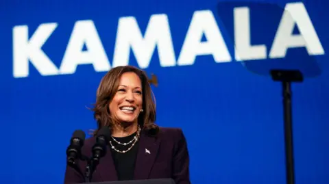 Getty Images Kamala Harris at a speech with her name written behind her