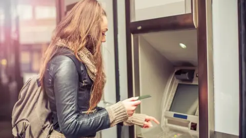 Getty Images woman at cash machine