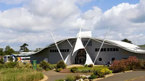 Getty Images A general shot of the Dinosaur Isle Museum, a large building with a curved roof. 